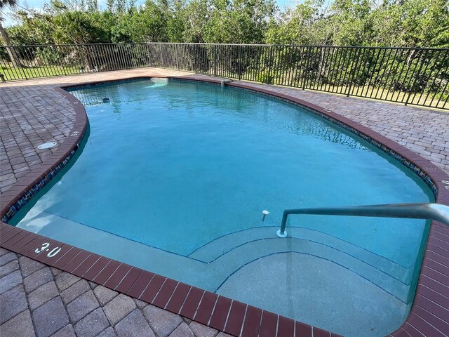 view of pool featuring a patio, fence, and a fenced in pool
