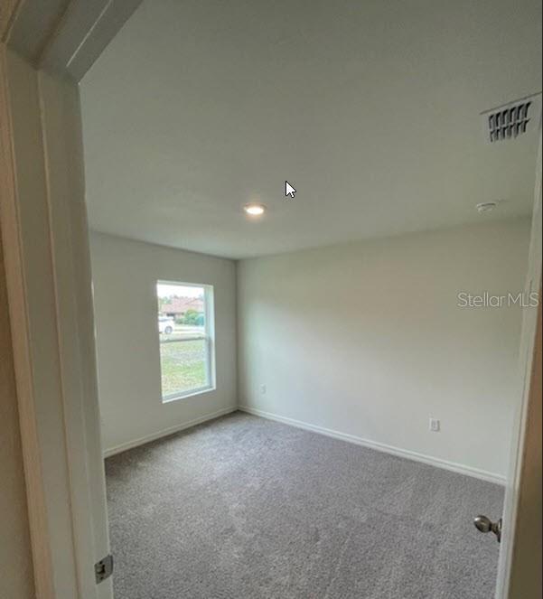 363 Underwood Trl, Palm Coast, FL 32164 - carpeted empty room with visible vents and baseboards