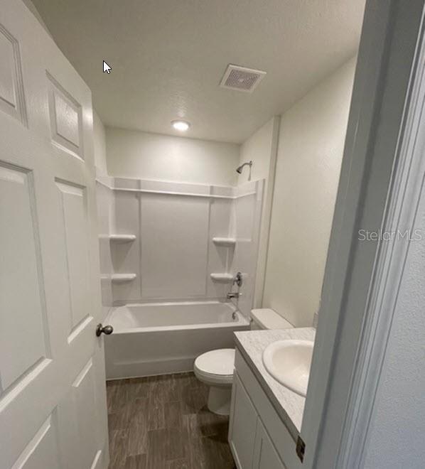 363 Underwood Trl, Palm Coast, FL 32164 - full bathroom featuring visible vents, toilet, shower / bathing tub combination, wood finished floors, and vanity