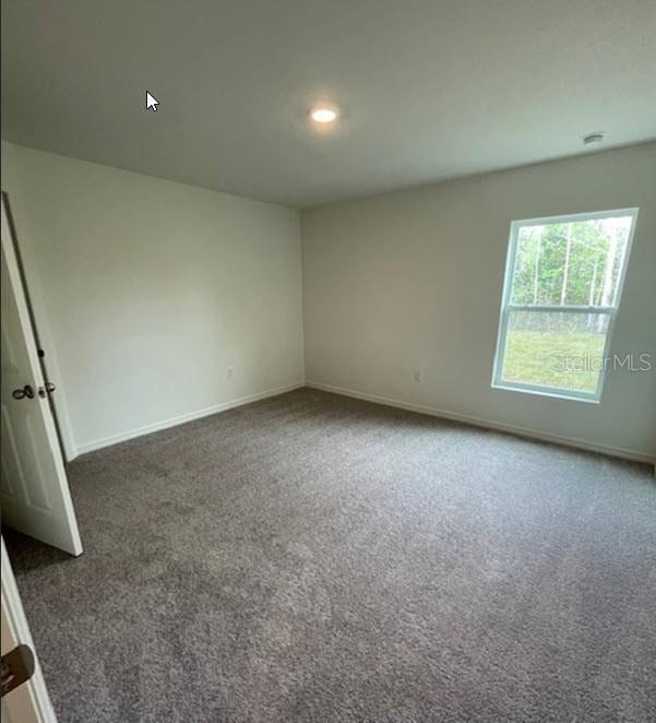 363 Underwood Trl, Palm Coast, FL 32164 - spare room featuring carpet and baseboards