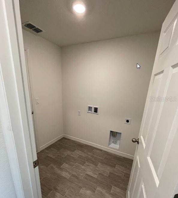 363 Underwood Trl, Palm Coast, FL 32164 - clothes washing area featuring visible vents, laundry area, electric dryer hookup, washer hookup, and dark wood-type flooring