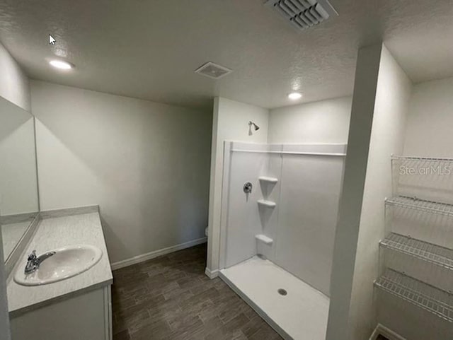 363 Underwood Trl, Palm Coast, FL 32164 - full bathroom with visible vents, walk in shower, wood finished floors, and vanity