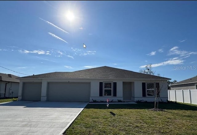 single story home with a garage and a front lawn