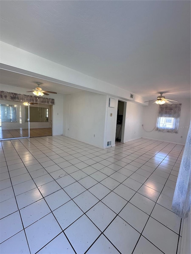 spare room featuring light tile patterned floors and ceiling fan