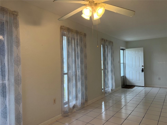 entryway featuring ceiling fan, baseboards, and light tile patterned floors