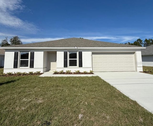 ranch-style home with a front lawn, concrete driveway, and stucco siding