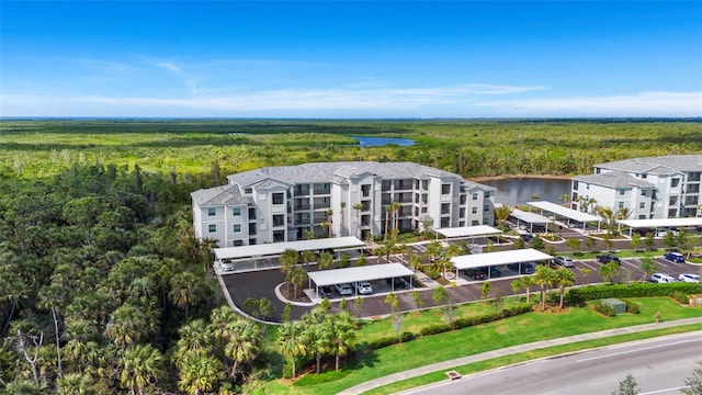 drone / aerial view with a water view and a view of trees