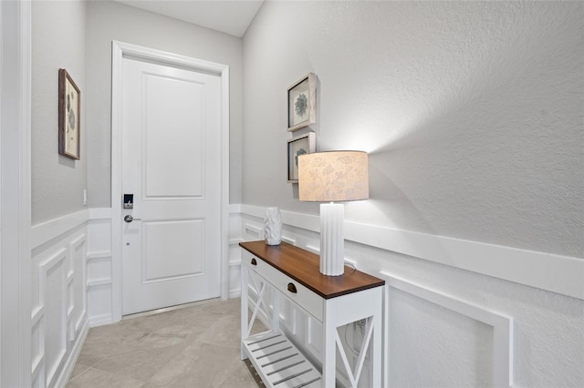 entryway featuring a wainscoted wall