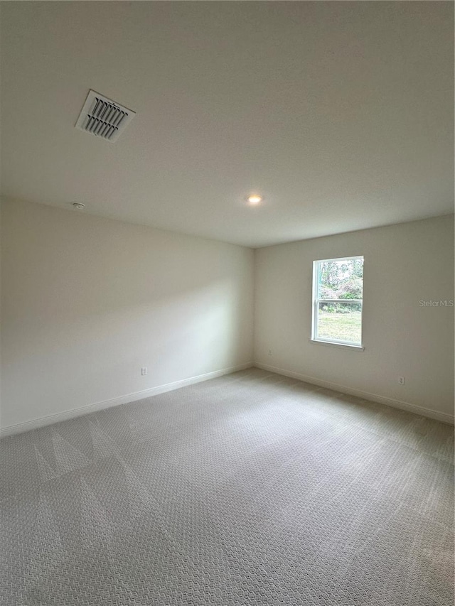 spare room featuring recessed lighting, baseboards, visible vents, and carpet flooring