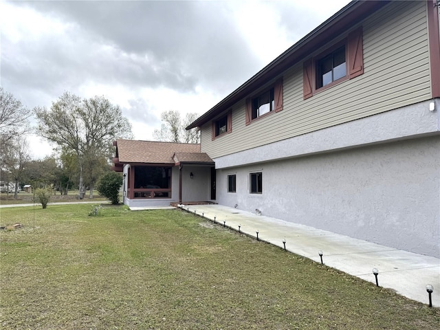 back of house with a lawn