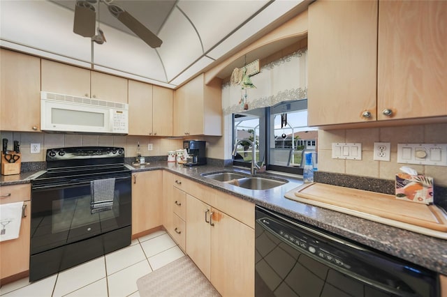 kitchen featuring tasteful backsplash, a sink, black appliances, and light tile patterned floors