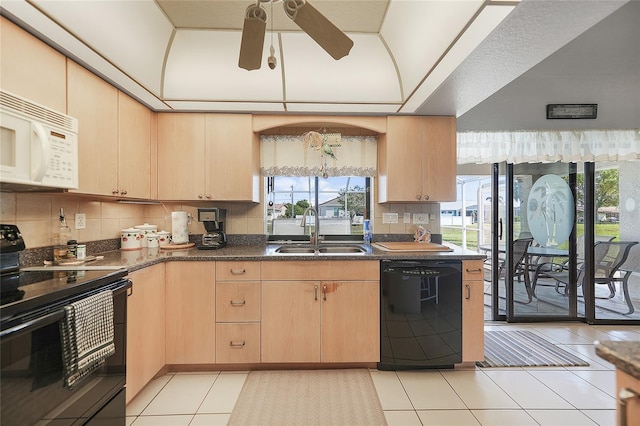 kitchen with decorative backsplash, black appliances, light brown cabinets, a sink, and light tile patterned flooring