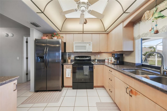 kitchen with white microwave, light brown cabinets, a sink, black range with electric cooktop, and stainless steel fridge with ice dispenser