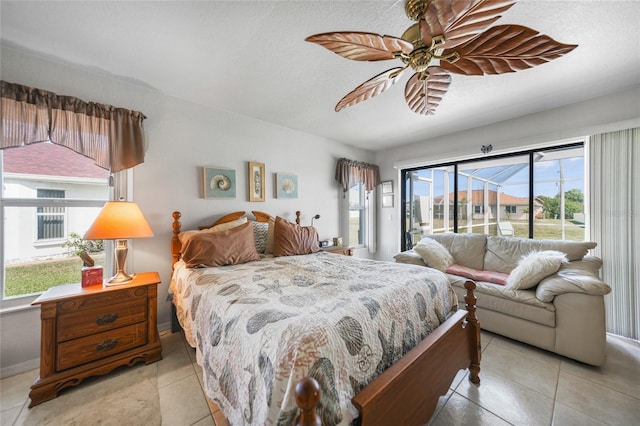 bedroom with a ceiling fan, access to exterior, a textured ceiling, and light tile patterned floors