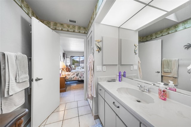 ensuite bathroom featuring vanity, tile patterned flooring, ensuite bath, and visible vents