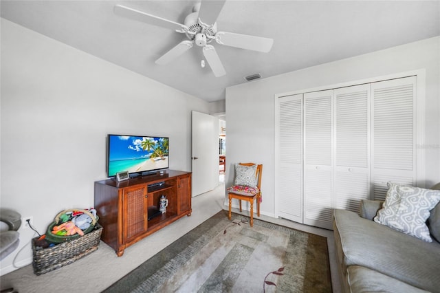 living room with a ceiling fan, light colored carpet, and visible vents