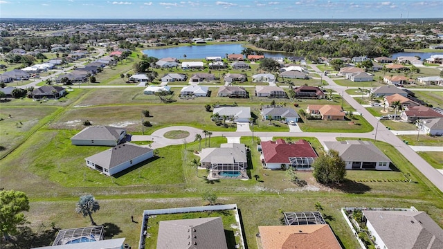 birds eye view of property with a water view and a residential view