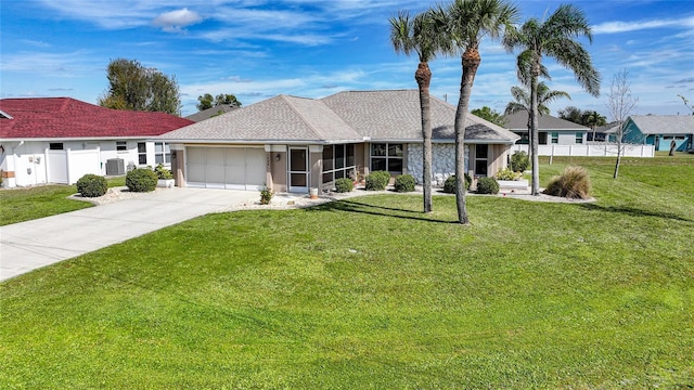 ranch-style home with a garage, concrete driveway, fence, and a front lawn