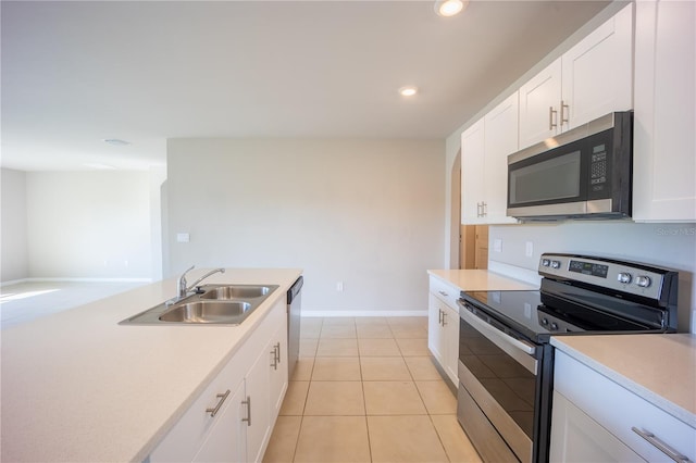 kitchen featuring a sink, white cabinetry, recessed lighting, appliances with stainless steel finishes, and light countertops