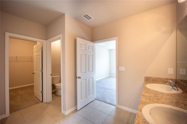 bathroom with a sink, visible vents, toilet, and tile patterned floors