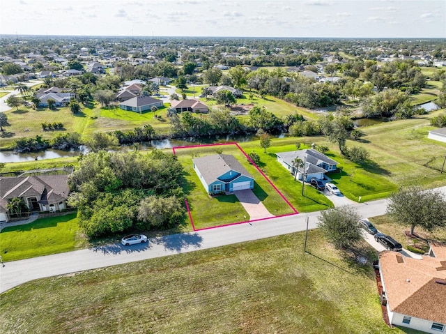 drone / aerial view featuring a residential view and a water view