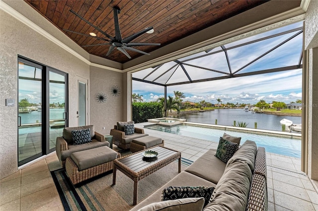 view of patio with an outdoor hangout area, glass enclosure, a water view, and a ceiling fan