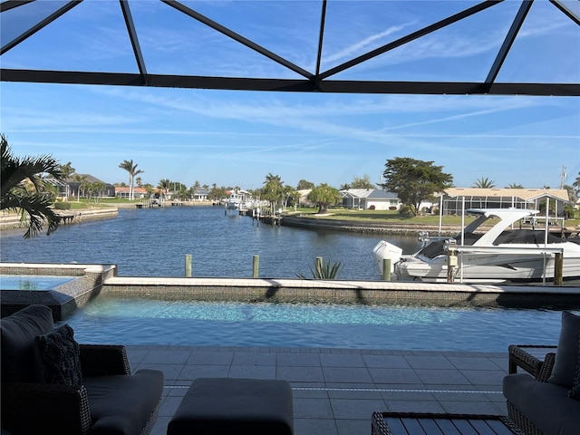 dock area featuring a water view, a lanai, and a pool with connected hot tub