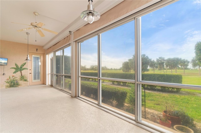 unfurnished sunroom with ceiling fan