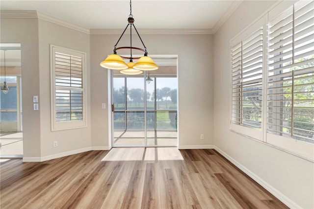 interior space featuring ornamental molding, baseboards, and wood finished floors