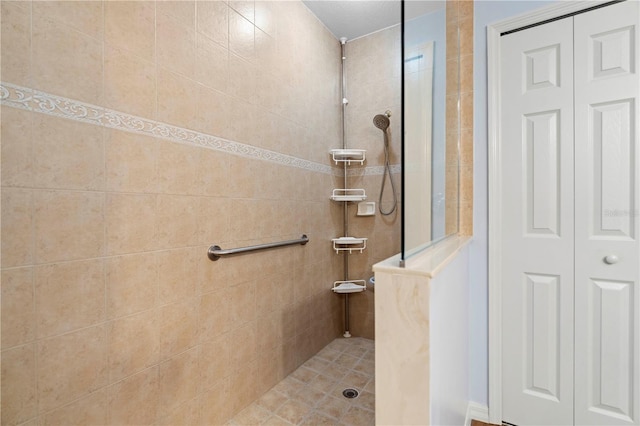 bathroom with a closet and walk in shower