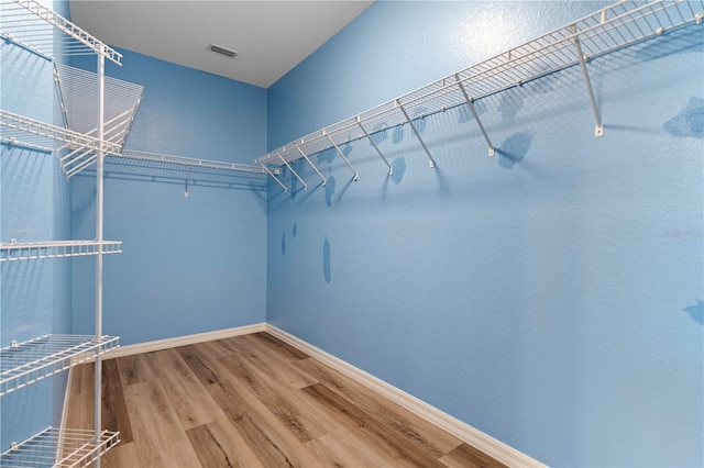 spacious closet with wood finished floors