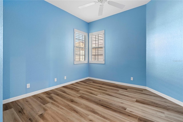 unfurnished room featuring ceiling fan, baseboards, and light wood-style floors