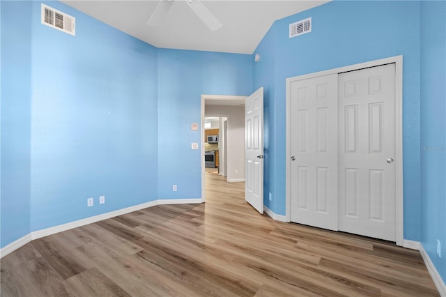 unfurnished bedroom featuring ceiling fan, visible vents, baseboards, and light wood-type flooring