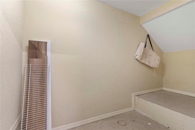 interior space with baseboards and lofted ceiling