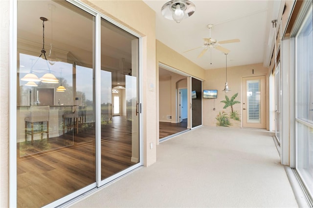 sunroom with a ceiling fan