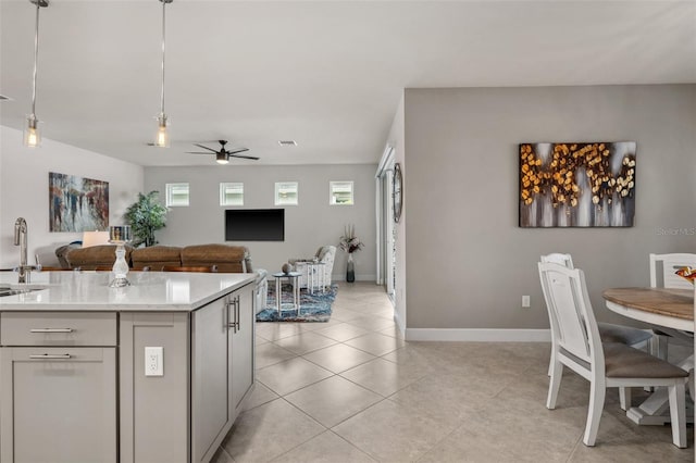 kitchen featuring sink, light tile patterned floors, ceiling fan, and decorative light fixtures