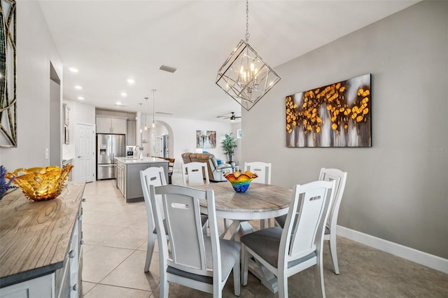 tiled dining area featuring ceiling fan and sink