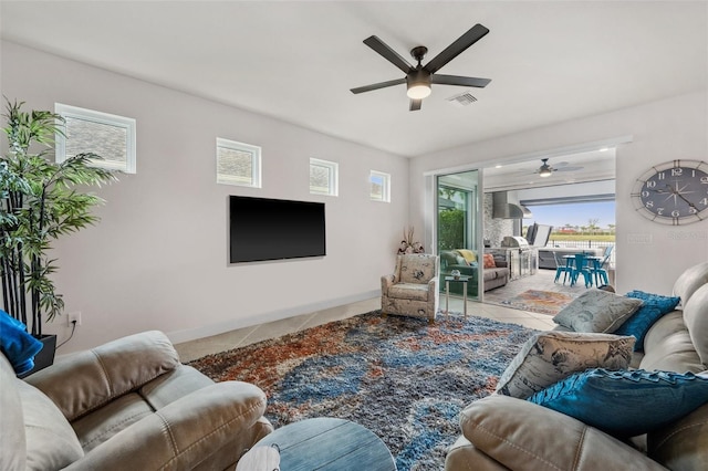 tiled living room with ceiling fan