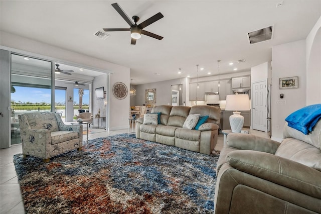 living room with ceiling fan and light tile patterned floors