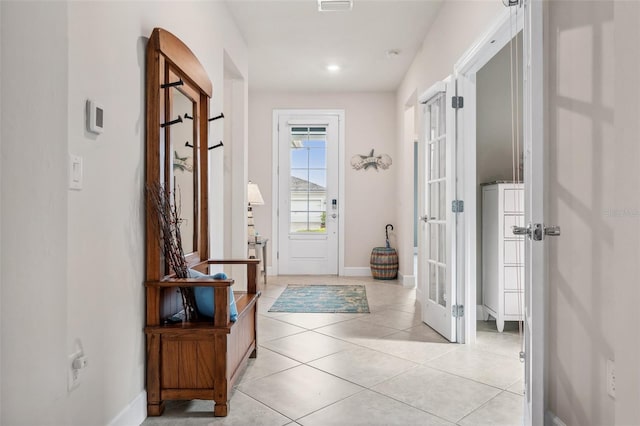 entryway with french doors and light tile patterned floors