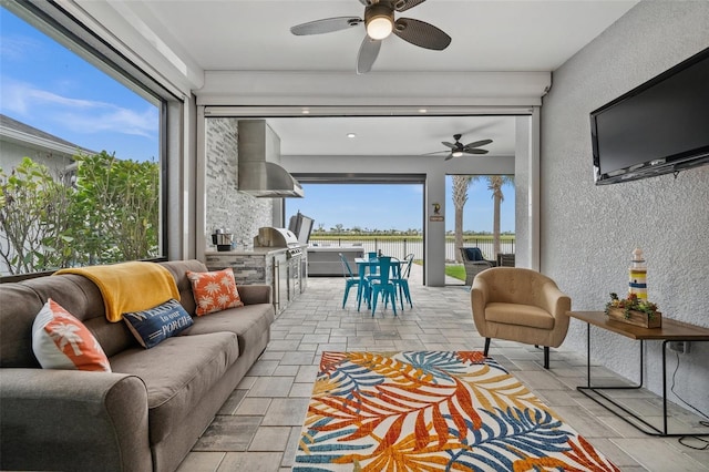 sunroom / solarium featuring ceiling fan