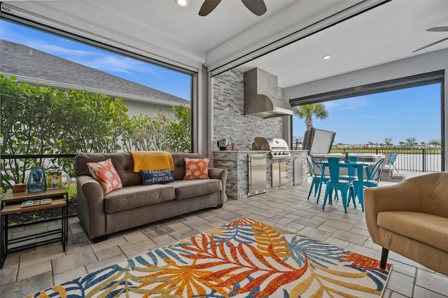 sunroom with a healthy amount of sunlight and ceiling fan