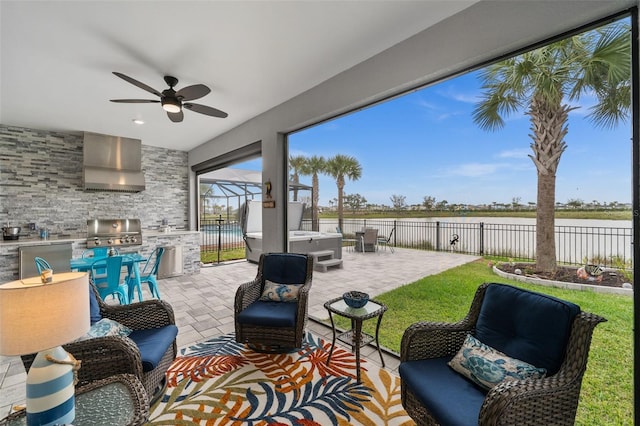 view of patio / terrace featuring an outdoor living space, ceiling fan, a grill, and exterior kitchen