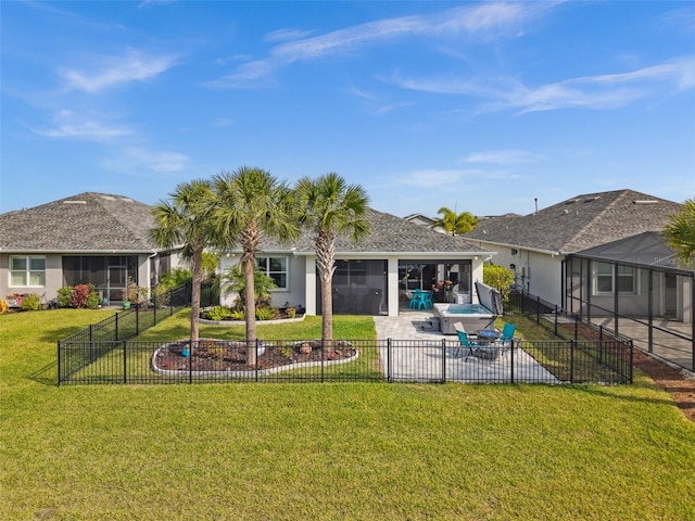 rear view of property with a patio area, a yard, and a sunroom