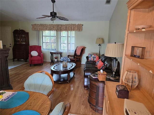 living room with wood-type flooring and ceiling fan