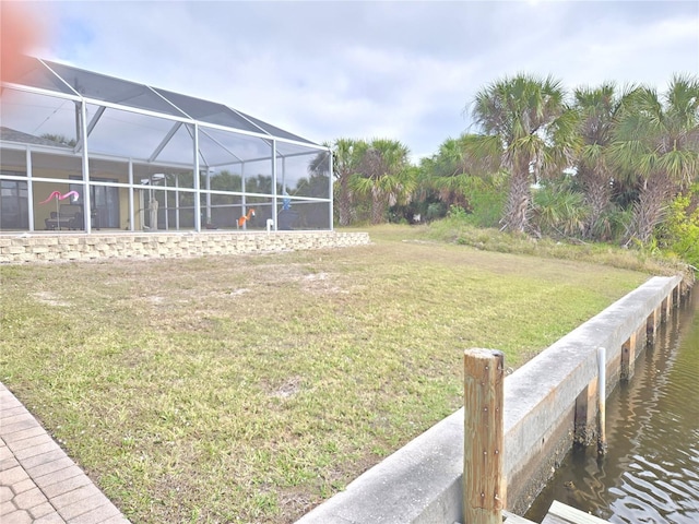 view of yard with a water view and a lanai