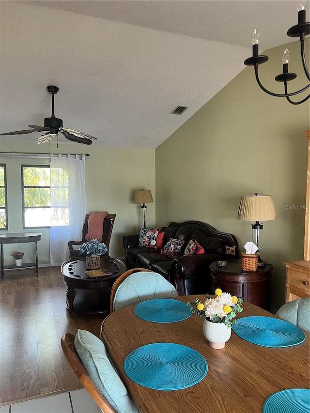 dining space with lofted ceiling, ceiling fan, visible vents, and dark wood-style flooring