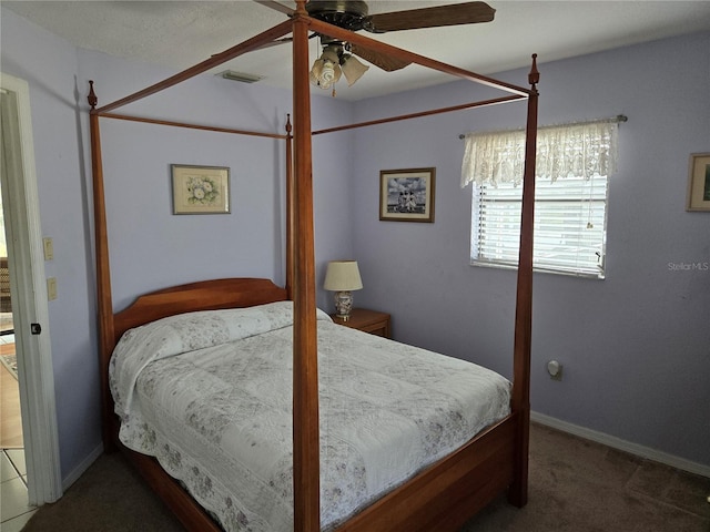 bedroom with a ceiling fan, visible vents, dark carpet, and baseboards