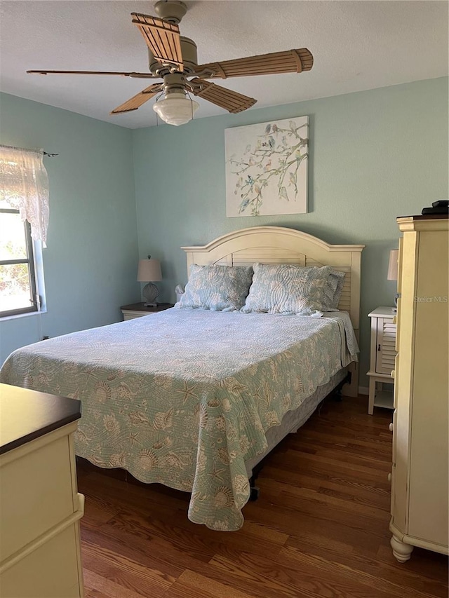 bedroom with dark wood-style floors and ceiling fan