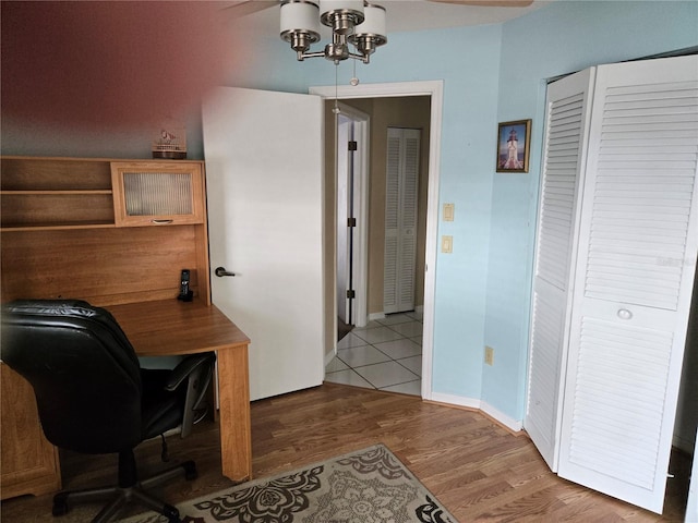 office featuring a chandelier, wood finished floors, and baseboards